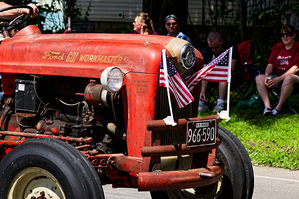 Miami, Florida, Unites States of America - September 23, 2012: Young football fan wearing a Miami Dolphins jersey is posing next to a customized orange truck at Hard Rock Stadium, previously known as Sun Life Stadium, in Miami, showcasing team spirit and a love for the game