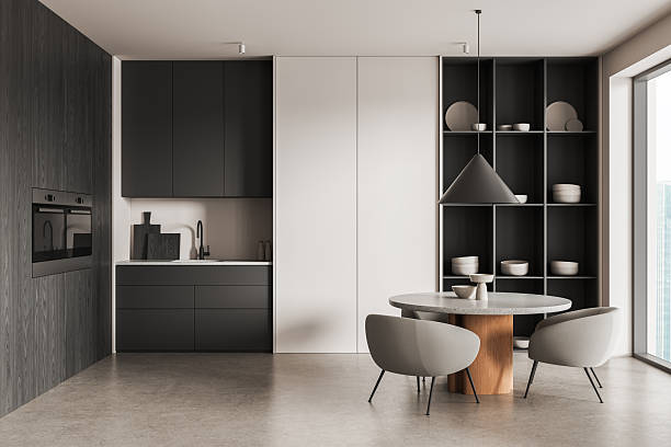istock Modern kitchen and dining interior with minimalist furniture, round table, open shelving, and sleek cabinetry in neutral tones and soft lighting. 3D Rendering 2250495273