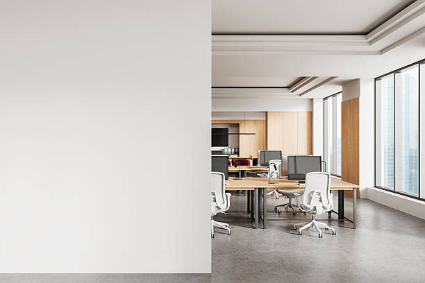 istock Modern office interior with blank white wall on left side for poster mockup or art display in clean, bright corporate workspace concept layout. 3D Rendering 2250495452