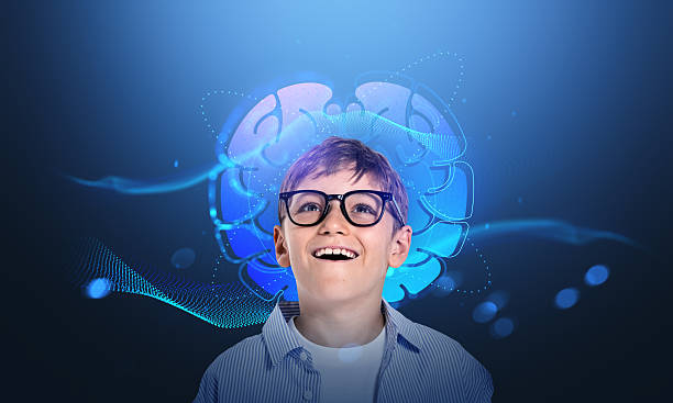 istock Smiling boy with glasses looking amazed in front of glowing blue 2250496313