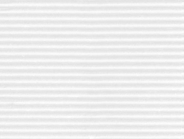Table top high angle view of old textured gray white colored grayscale striped grooved corrugated full frame cardboard or paperboard, packaging material, packing for shipping, or tin roof, rooftop.