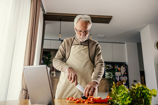 istock Senior man learning healthy cooking with digital tablet 2250498381