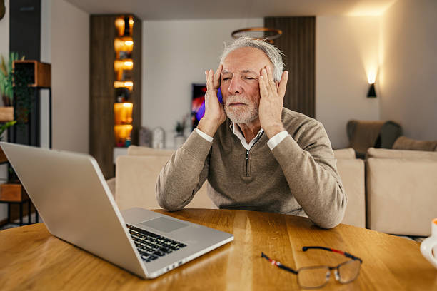 istock Senior man experiencing headache from work stress at home 2250498509