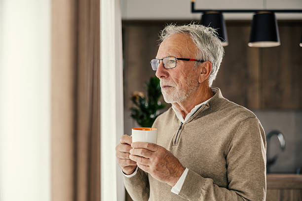 istock Senior man contemplating life holding coffee mug 2250498539