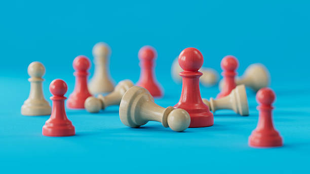 istock Red Pawn Standing Amid Fallen Beige and Red Pieces: Symbolizing Resilience 2250498587