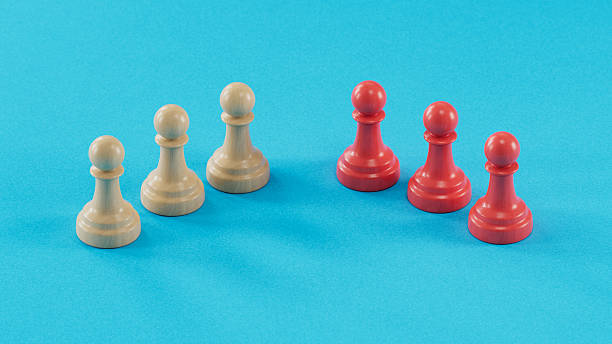 istock Beige and Red Pawn Groups Standing Separated: Embodying Duality 2250498595
