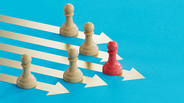 istock Red Pawn Leading Beige: Symbolizing Leadership Across Diverging Paths 2250498631