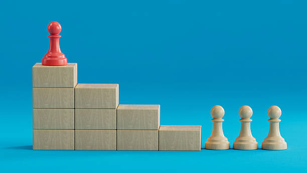 istock Red Pawn Tops Stepped Tower: Leadership Amid Ranked Progression 2250498634