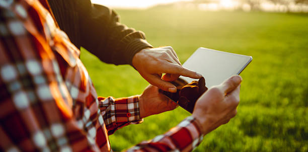 istock Farmers in a field working on a digital tablet. Close-up. 2250498644