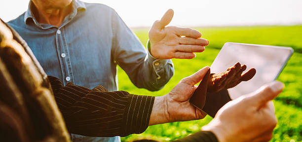 istock Farmers in a field working on a digital tablet. Close-up. 2250498656