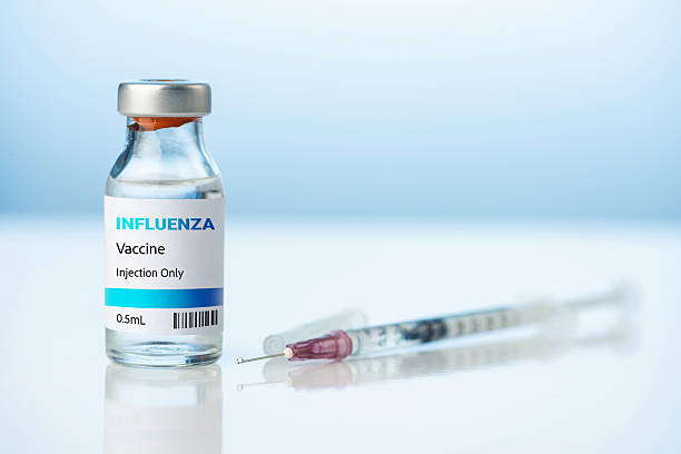 istock Influenza Vaccine Vial and Sterile Syringe  Flu Shot Immunization Concept 2250500049