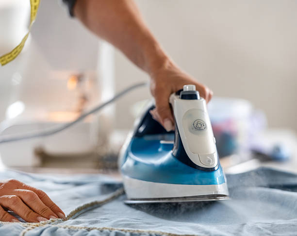 istock Woman Ironing Fabric Before Sewing 2250500420