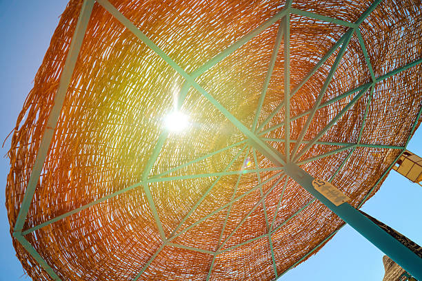 wicker umbrella beach against the sky.