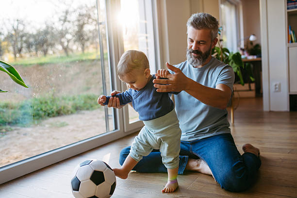 istock Father playing with little son, playing footbal. 2250503281