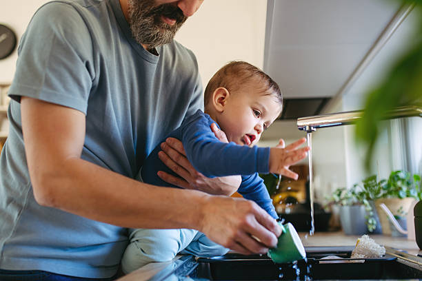 istock Father caring for toddler son while doing household chores. 2250503399