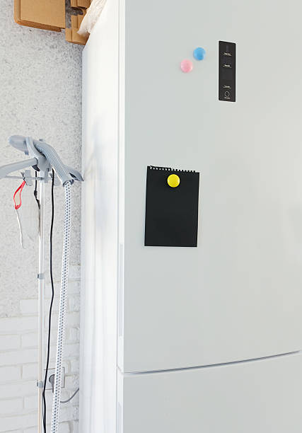 istock Blank black note board with magnets on refrigerator in kitchen. Mockup for design 2250503761