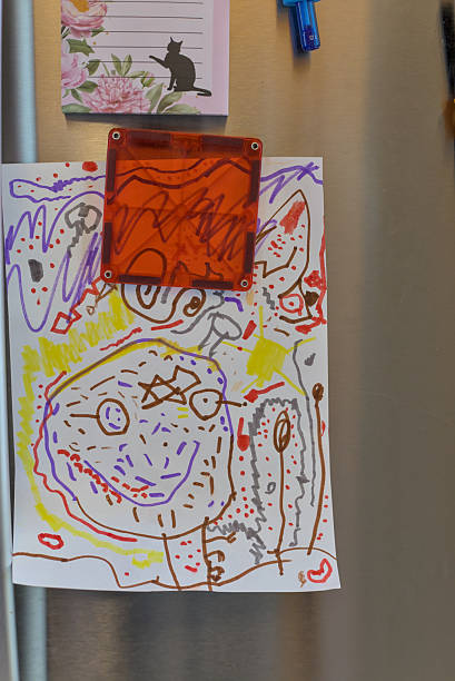 istock Child-drawn Artwork Decorating Refrigerator With Colors And Imagination. 2250504208