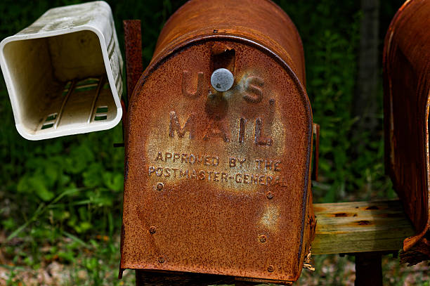 Rusty vintage mailbox stands weathered with faded 