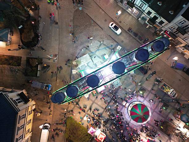 Illuminated ferris wheel at night during Berlin Christmas market.