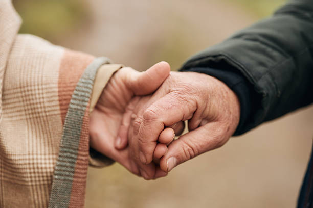 istock Senior couple holding hands showing love and devotion 2250508692
