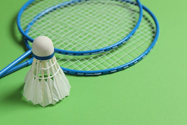 istock Badminton rackets and white badminton shuttlecock on color background 2250509095