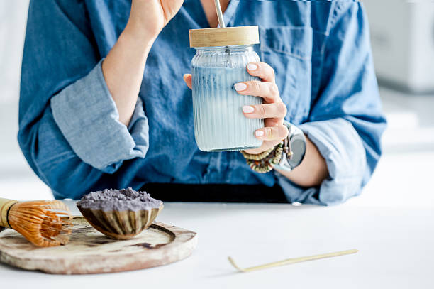 Woman Drinks Blue Iced Matcha Latte