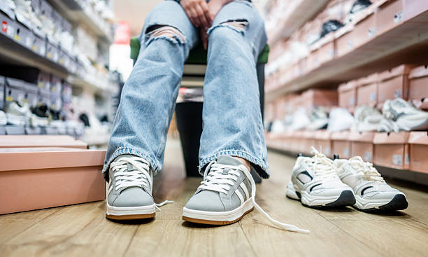 istock Girl Trying On Athletic Shoes 2250510189
