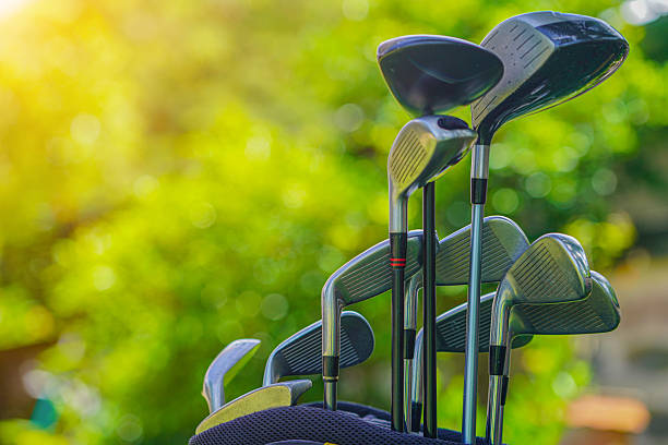 istock Golf bag and clubs in front of a blurred golf course background. 2250510334