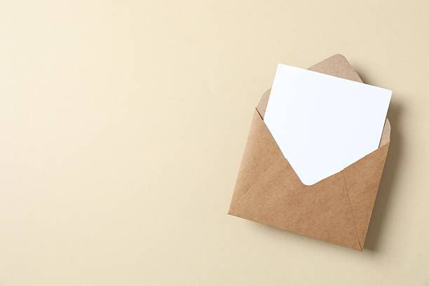 istock Craft envelope with white paper card on color background 2250510938
