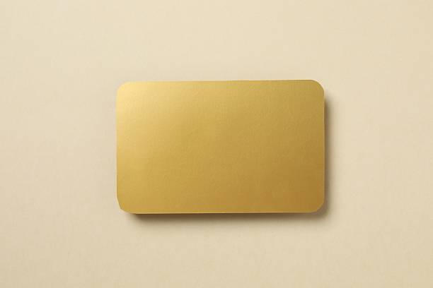 istock Golden paper card on color background 2250511021