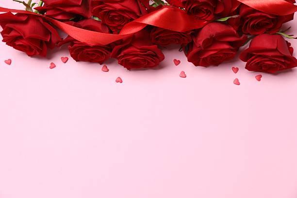 istock Beautiful red roses with hearts on color background 2250511950