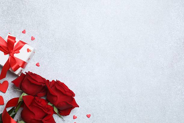 istock Beautiful red roses, gift box and hearts on grey background 2250512186