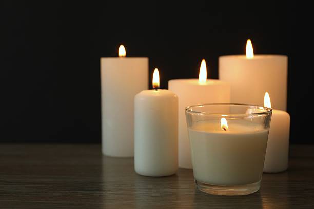 istock Burning candles in a dark space 2250512711