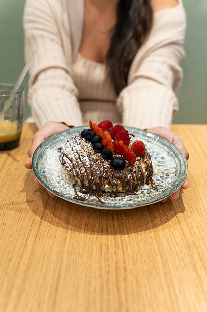 istock Woman serving chocolate pancakes with fresh berries 2250513030