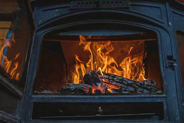 istock Bright orange flames burning inside rustic cast iron wood stove fireplace 2250513394