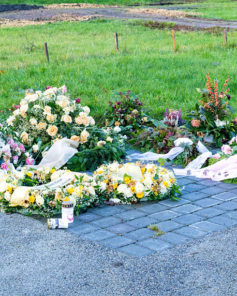istock Flower arrangements commemorating a person placed on a paved area 2250513449