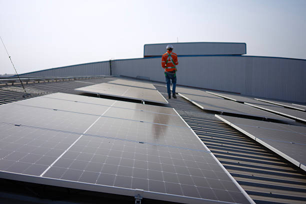 istock Blue collar worker is inspecting solar panel at rooftop of factory. 2250513569