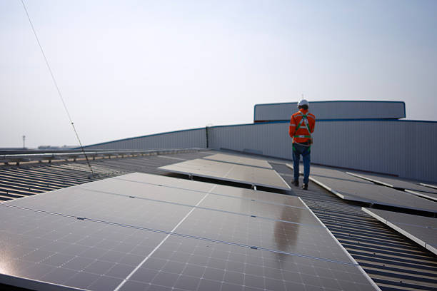 istock Blue collar worker is inspecting solar panel at rooftop of factory. 2250513570