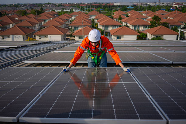 istock Blue collar worker is inspecting solar panel at rooftop of factory. 2250513631