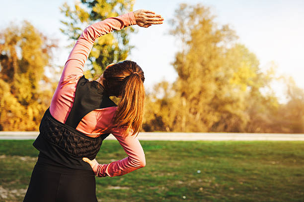 istock Rear view of fit doing warm up exercise before outdoor workout. 2250515868
