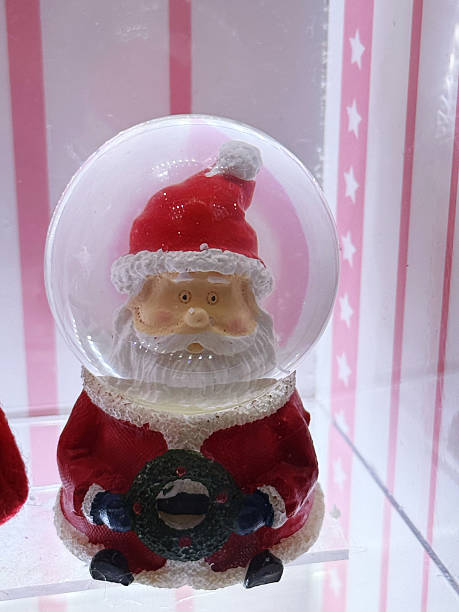 istock santa claus in a snow globe on a white background. 2250519528