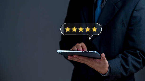 istock Business holding tablet pressing gold five stars symbol display. Client evaluation feedback rating satisfaction system. Top service quality assurance review reputation trust marketing technology. 2250522034