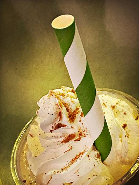 Whipped Cream topped Milkshake with a Green Striped Straw