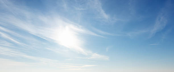 istock Sun is shining in wide blue sky with white cirrus clouds, natural panoramic background 2250524959