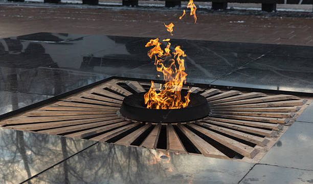 istock A symbolic memorial eternal flame burning in a circular structure with reflective surface 2250524961