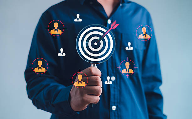 istock business professional holding a target icon with audience profile graphics, symbolizing customer targeting, segmentation, precision marketing, and data-driven business strategy. 2250525855