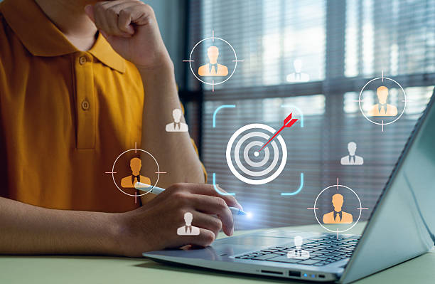 istock business professional analyzing customer targeting data on a laptop with digital icons of audience profiles and a bullseye, representing segmentation, precision marketing, and data-driven strategy. 2250525894