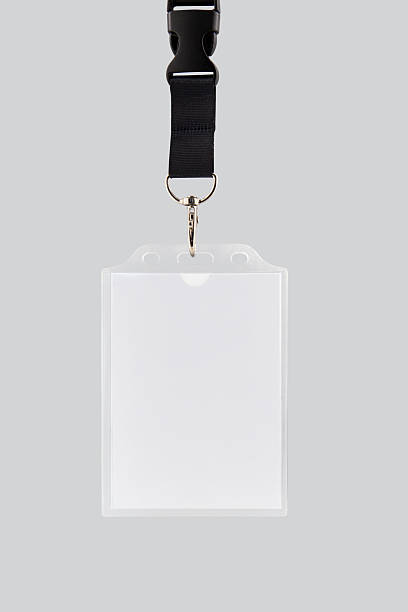 istock Blank ID badge attached to a black lanyard isolated on white background 2250527242