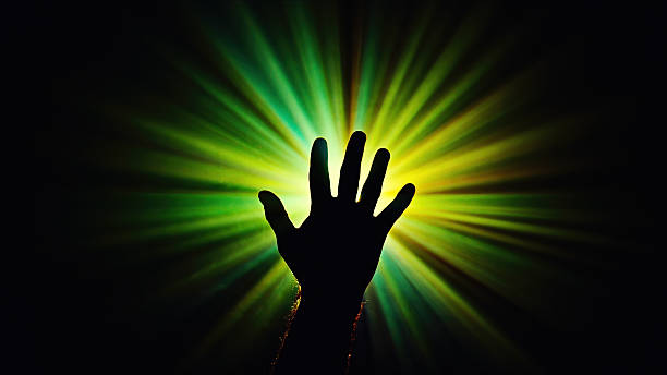 istock Hand is Reaching to Eternal Light Beam Rays 2250531389
