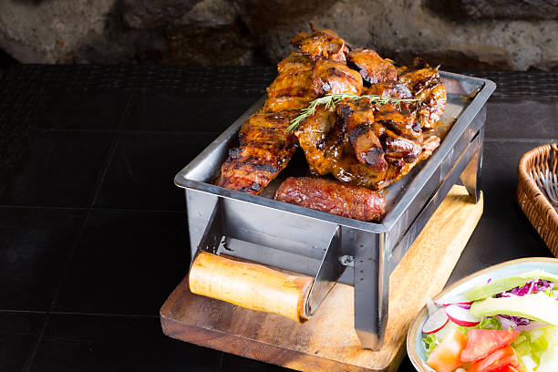 A plate of food with meat and vegetables on a wooden table